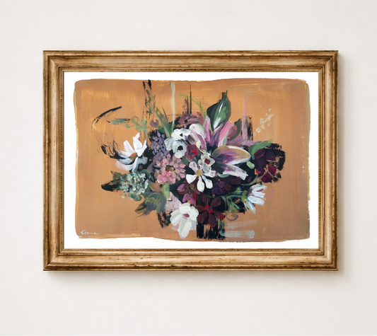 A framed floral painting featuring a bouquet of purple, white, and green flowers on a warm tan background, enclosed in a distressed gold frame and displayed against a light wall.